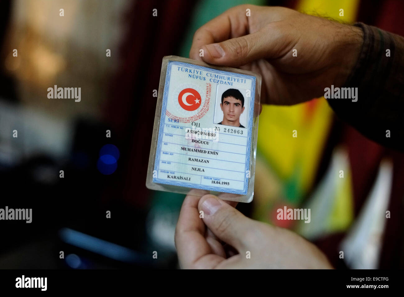 A fighter of the Kurdish People's Protection Units YPG holds Turkish identity card of captured ISIS ISIL or Daesh militant in the city of Qamishli or Qamishlo in Al Hasakah or Hassakeh district in northern Syria Stock Photo