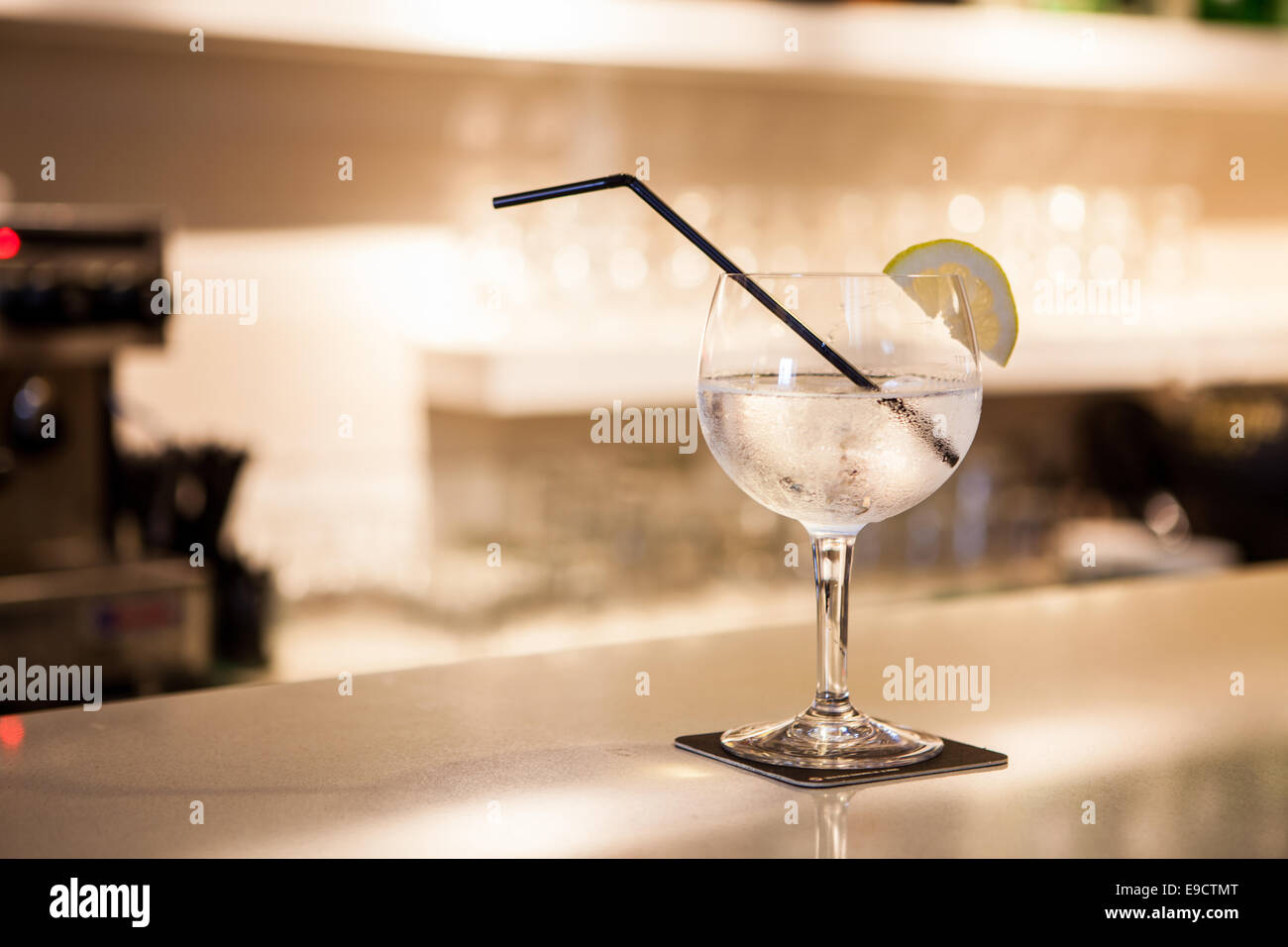 a cup of gin tonic with lemon on bar Stock Photo