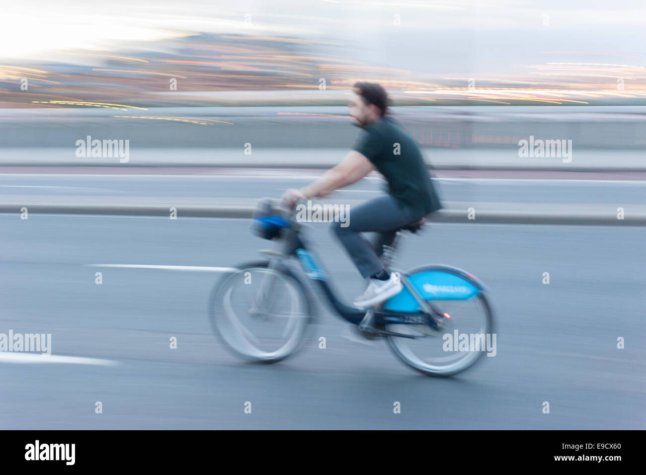 Man cycling on Boris bike with motion blur, London, UK Stock Photo