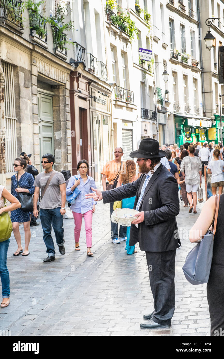 man with hat and jewish orthodox hairstyle asking for a donation, rue des rosiers, marais district,  paris, ile de france Stock Photo