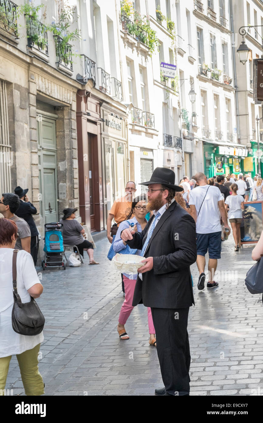 man with hat and jewish orthodox hairstyle asking for a donation, rue des rosiers, marais district,  paris Stock Photo