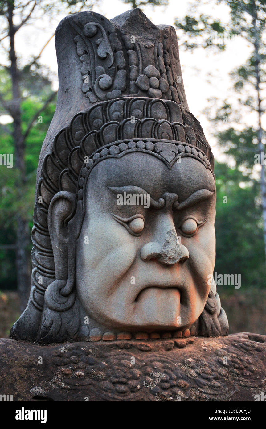 Single ancient giant stonework demon statue (asura) of a head and face lining path to  Angkor Thom, Siem Reap, Cambodia, Southeast Asia Stock Photo