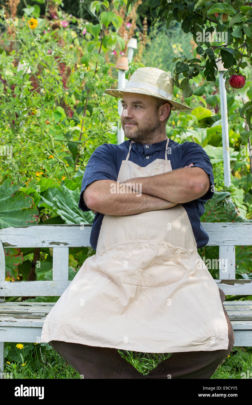 A man sitting on a bench in the garden Stock Photo - Alamy
