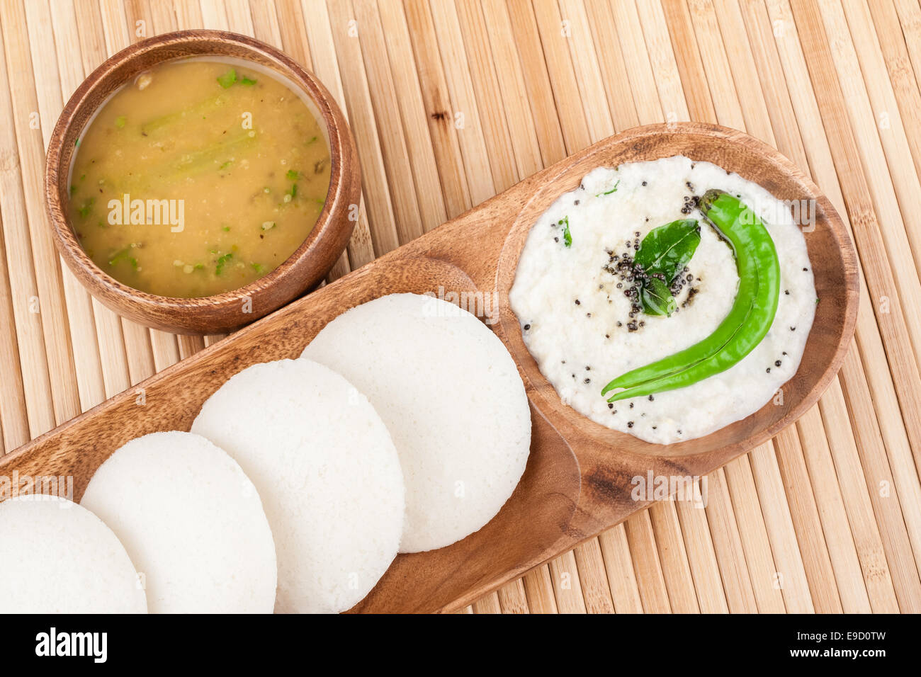 A traditional ethnic south Indian breakfast of Idly (Idli / rice cake) served with coconut chutney and sambar. Stock Photo