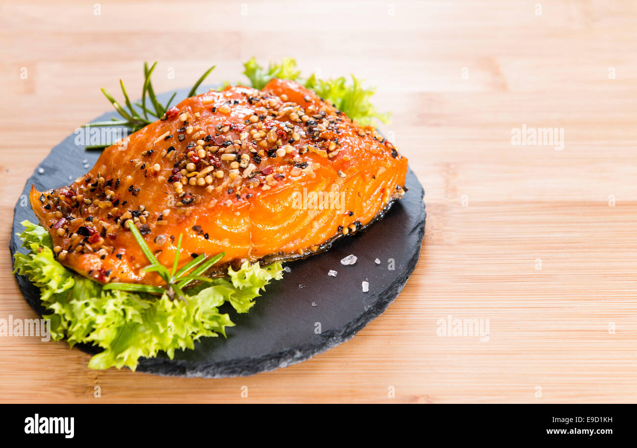 Portion of Smoked Salmon marinated with fresh herbs and spices on