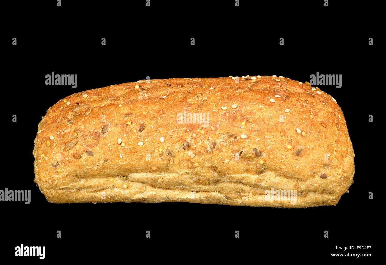 Large multigrain roll on a black background. Stock Photo
