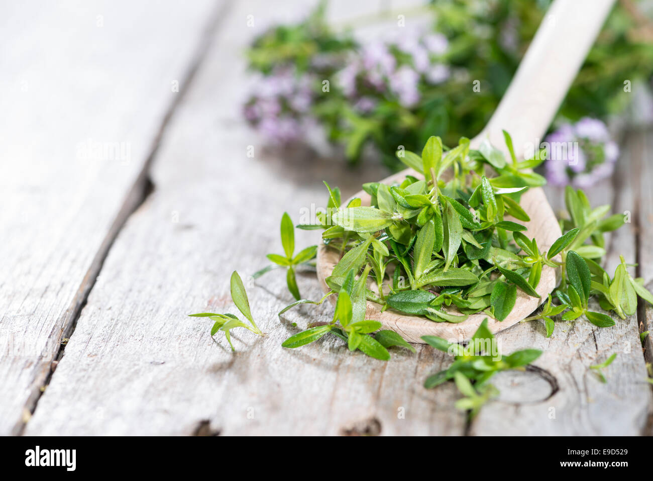 Portion of fresh Winter Savory (close-up shot) on a cooking spoon Stock Photo