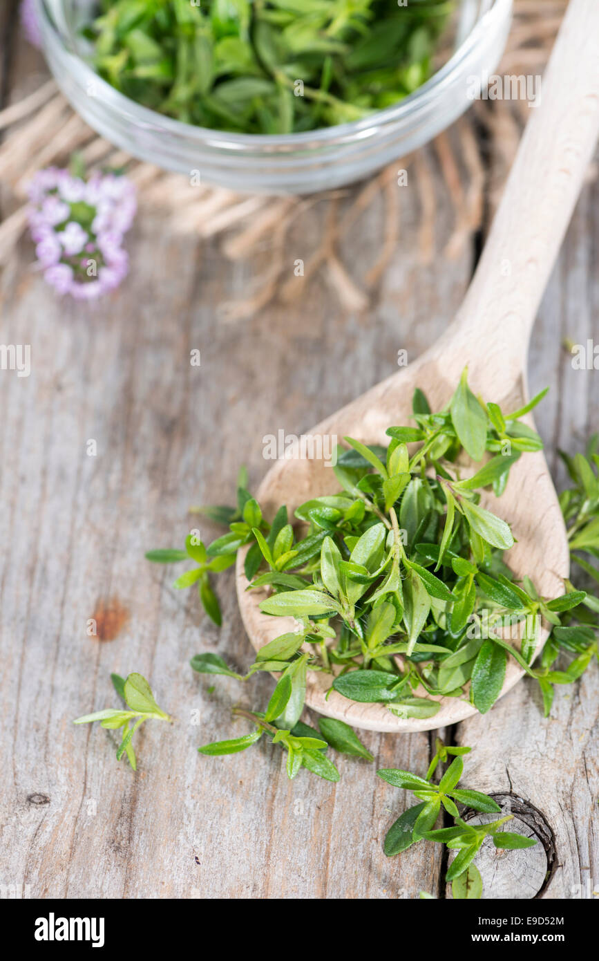 Portion of fresh Winter Savory (close-up shot) on a cooking spoon Stock Photo