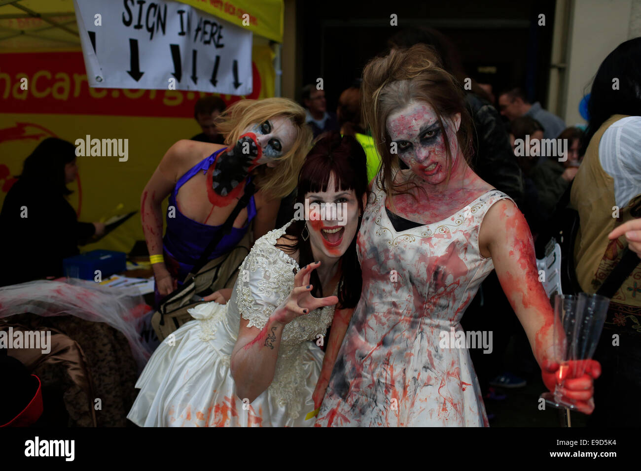 Glastonbury, Somerset, UK. 25 October 2014: Zombie hoards gather at Glastonbury for  annual Zombie walk where participants  dressed as marauding zombies lurch along the high street turning willing victims into the "undead"  This is the third annual Glastonbury Zombie Walk and is hosted by local charity, Martha Care, with all proceeds going toward supporting families with very sick children. Credit:  Tom Corban/Alamy Live News Stock Photo