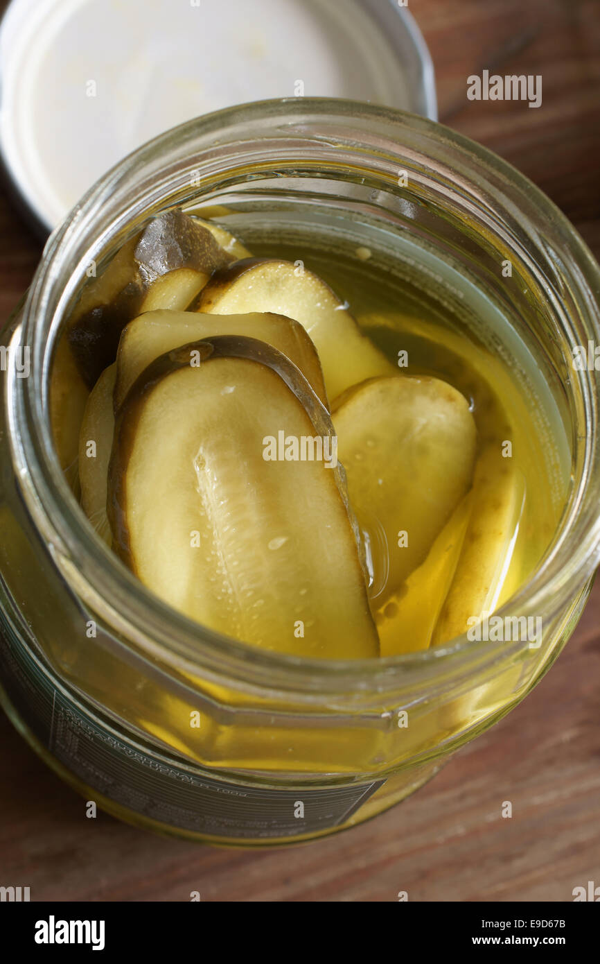 Sliced pickles or pickled gherkins in vinegar Stock Photo