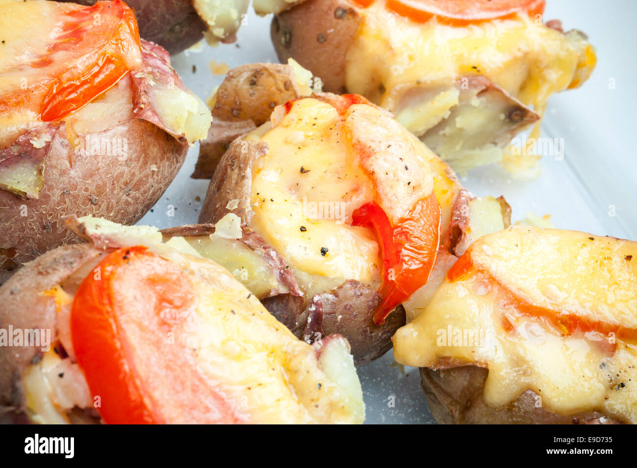 Hot homemade baked potato with tomato, bacon and cheese Stock Photo