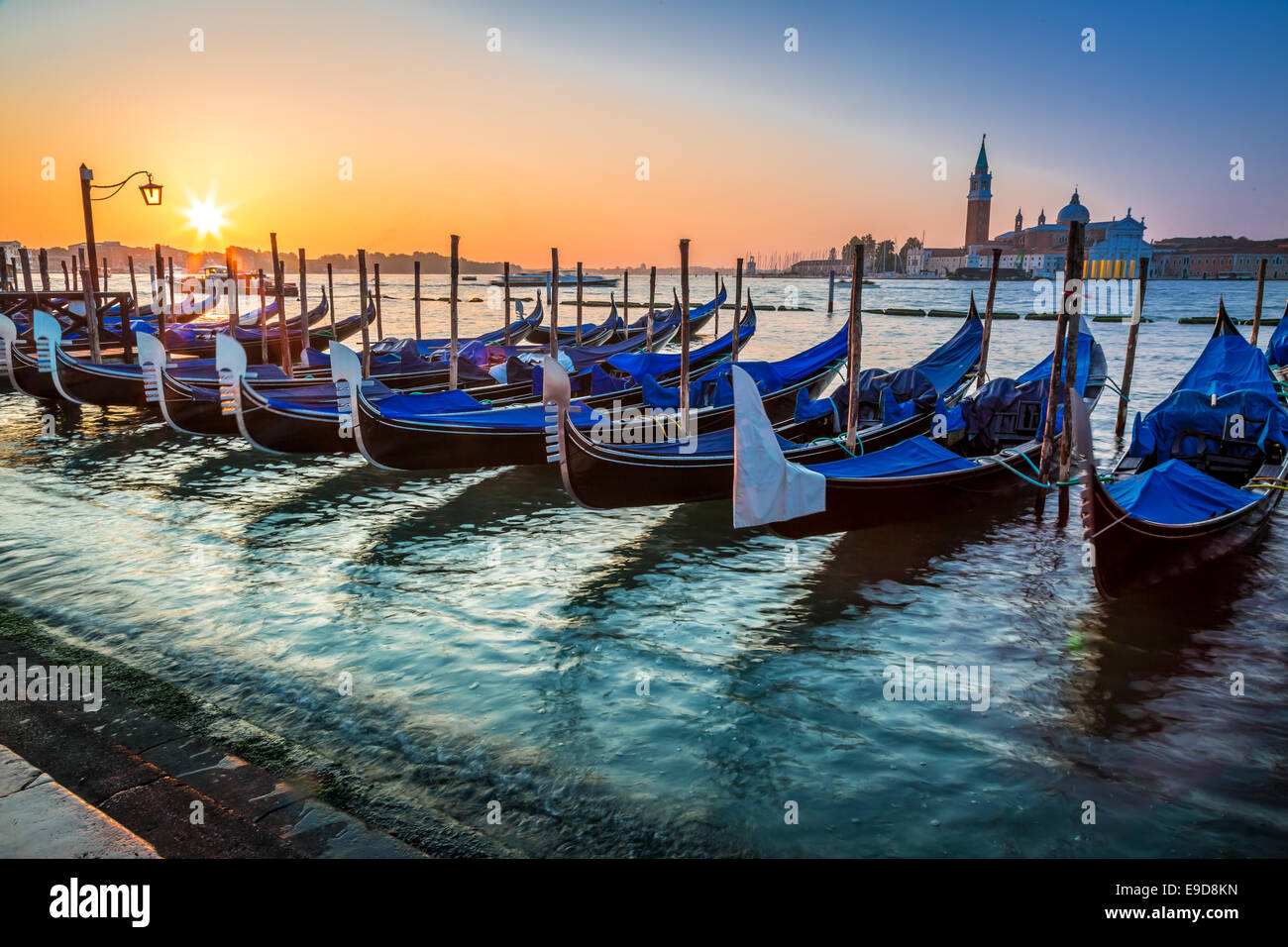 Blue gondolas at sunrise in Venice Stock Photo - Alamy