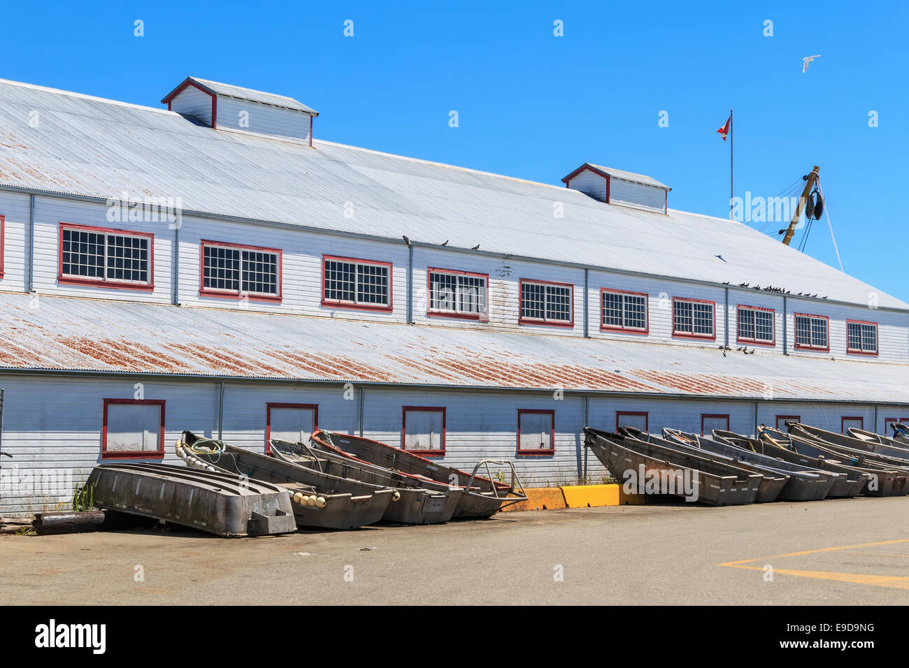 Industrial warehouse and boats in the fishing port. Stock Photo