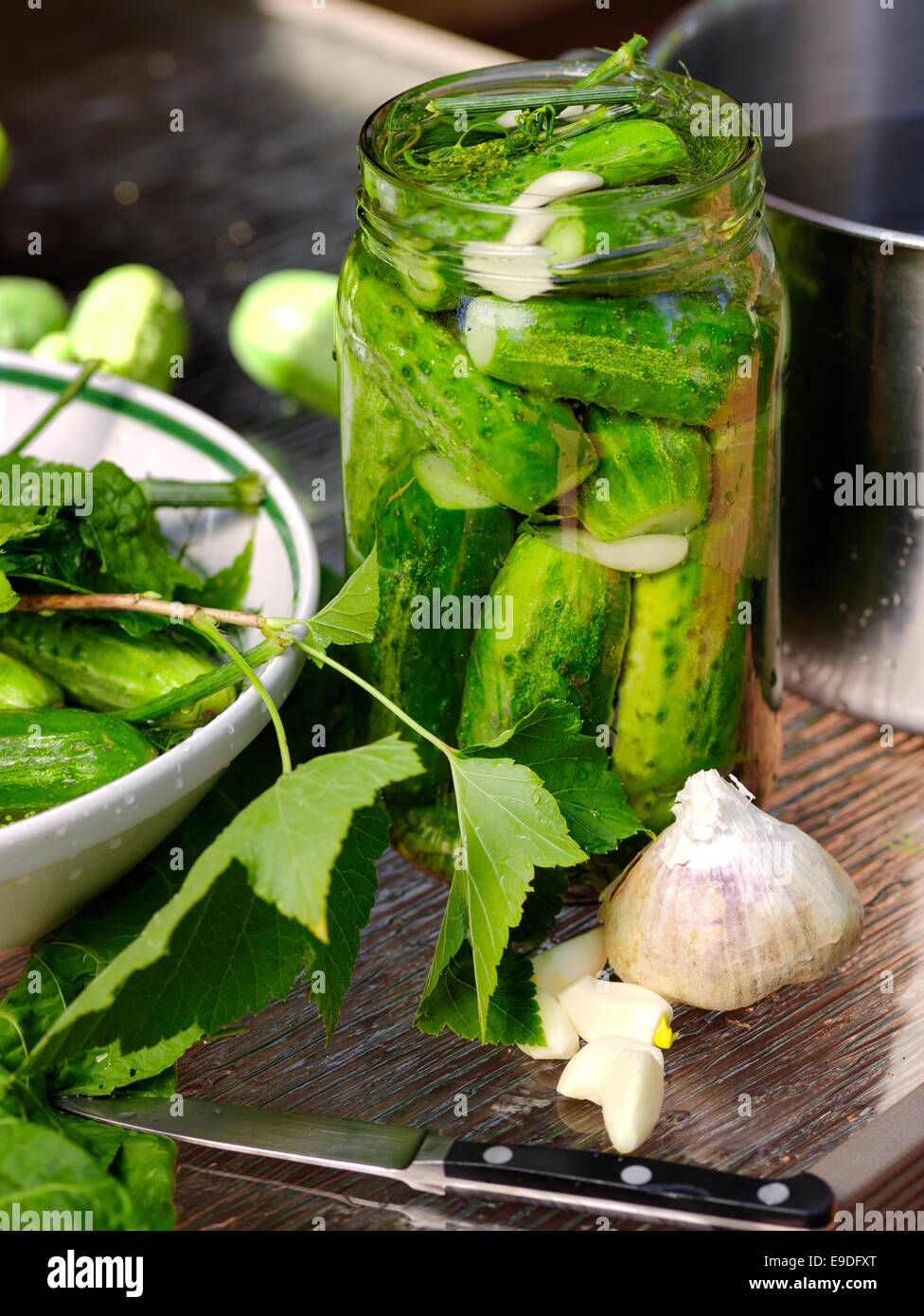 Pickles stuffed in the glass jars ready for pickling. Stock Photo