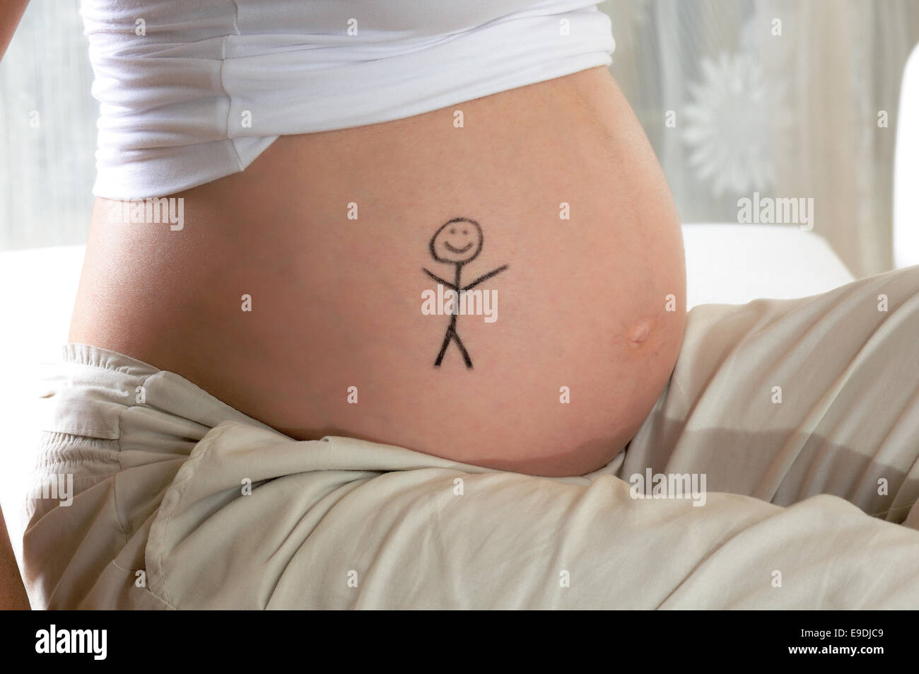 belly of a pregnant young woman in her sixth month Stock Photo