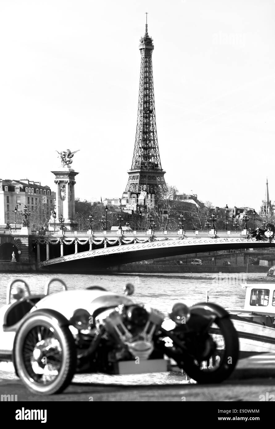 Vintage picture of Eiffel tower with old car on foreground, Paris. Stock Photo