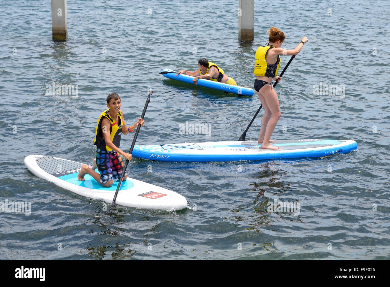 BARCELONA - JUN 28: People doing Stand up paddle surfing, or boarding (SUP), at LKXA Extreme Sports Barcelona Games. Stock Photo