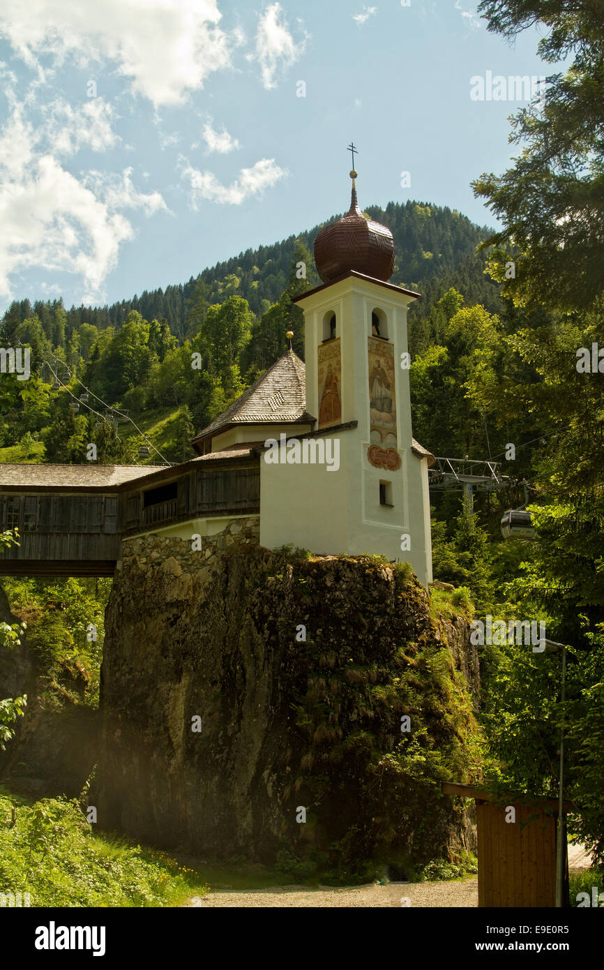 The beautiful and unique Stampfanger Chapel sits on an outcrop of rock  above the lovely Austrian apline  town of Soll .  . Stock Photo