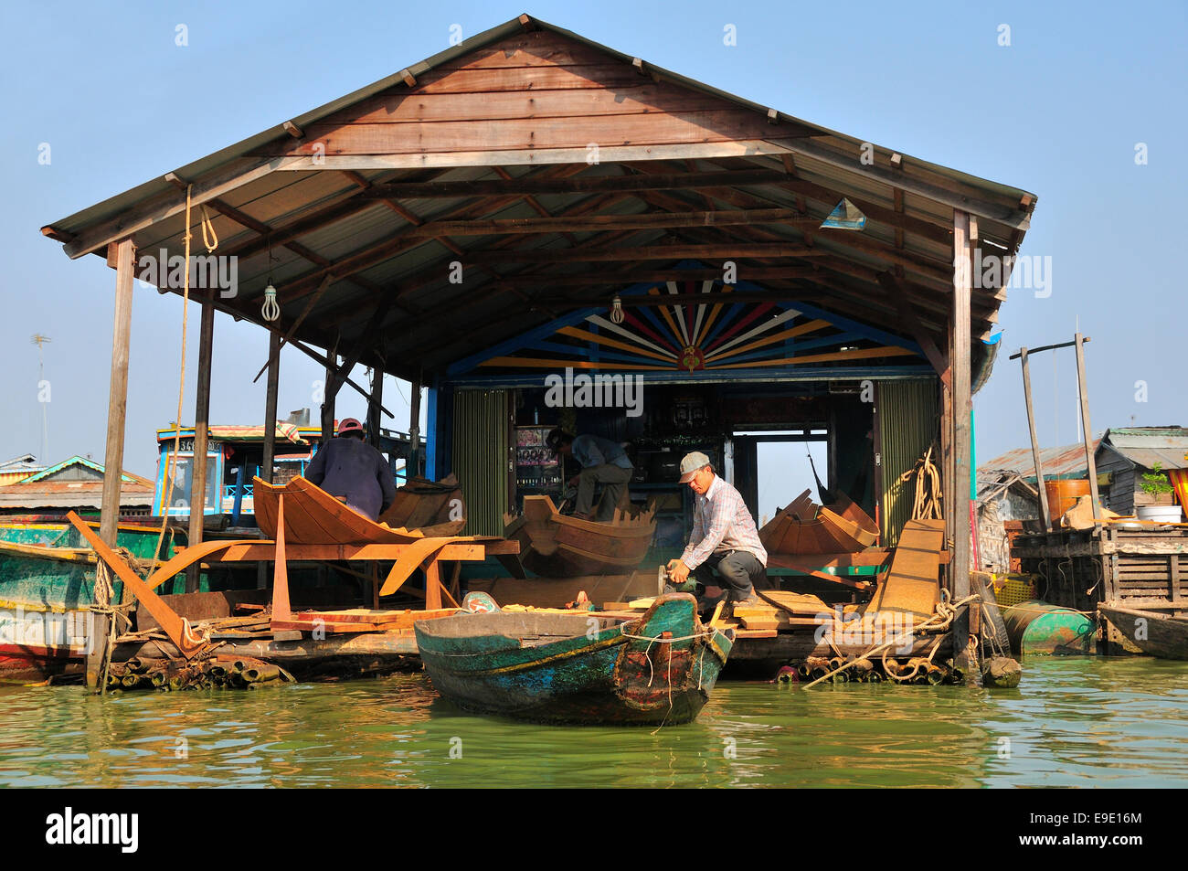 Boat builders working on their floating boatyard  on the Tonle Sap Lake, Cambodia,South East Asia Stock Photo
