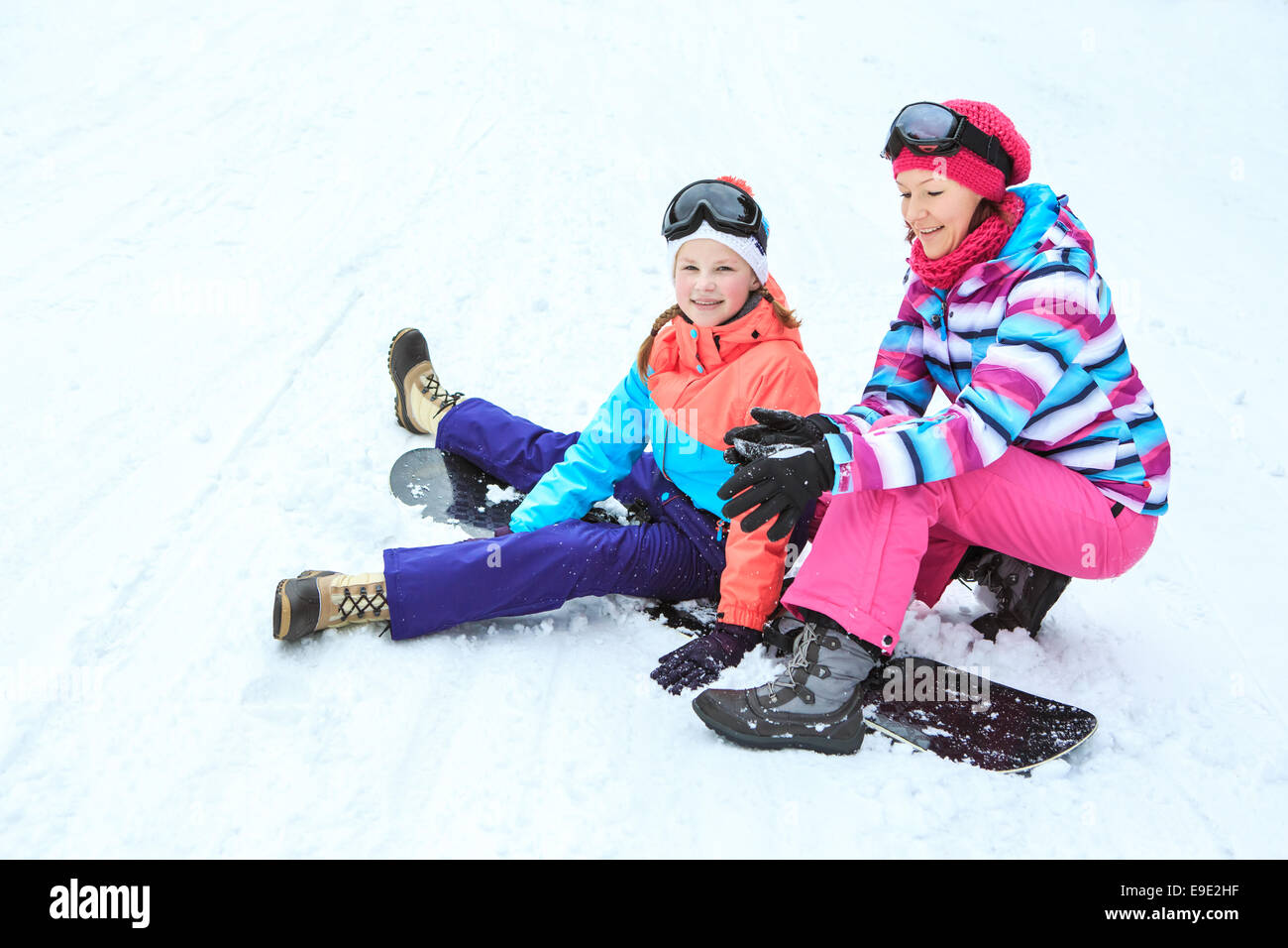 teenage girls riding sledge in the Alps Stock Photo
