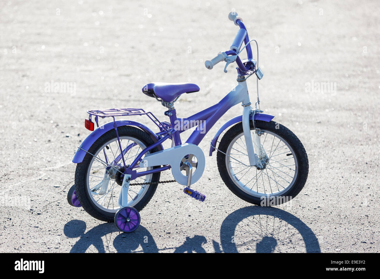 Small kids bike with training wheels outdoors. Stock Photo