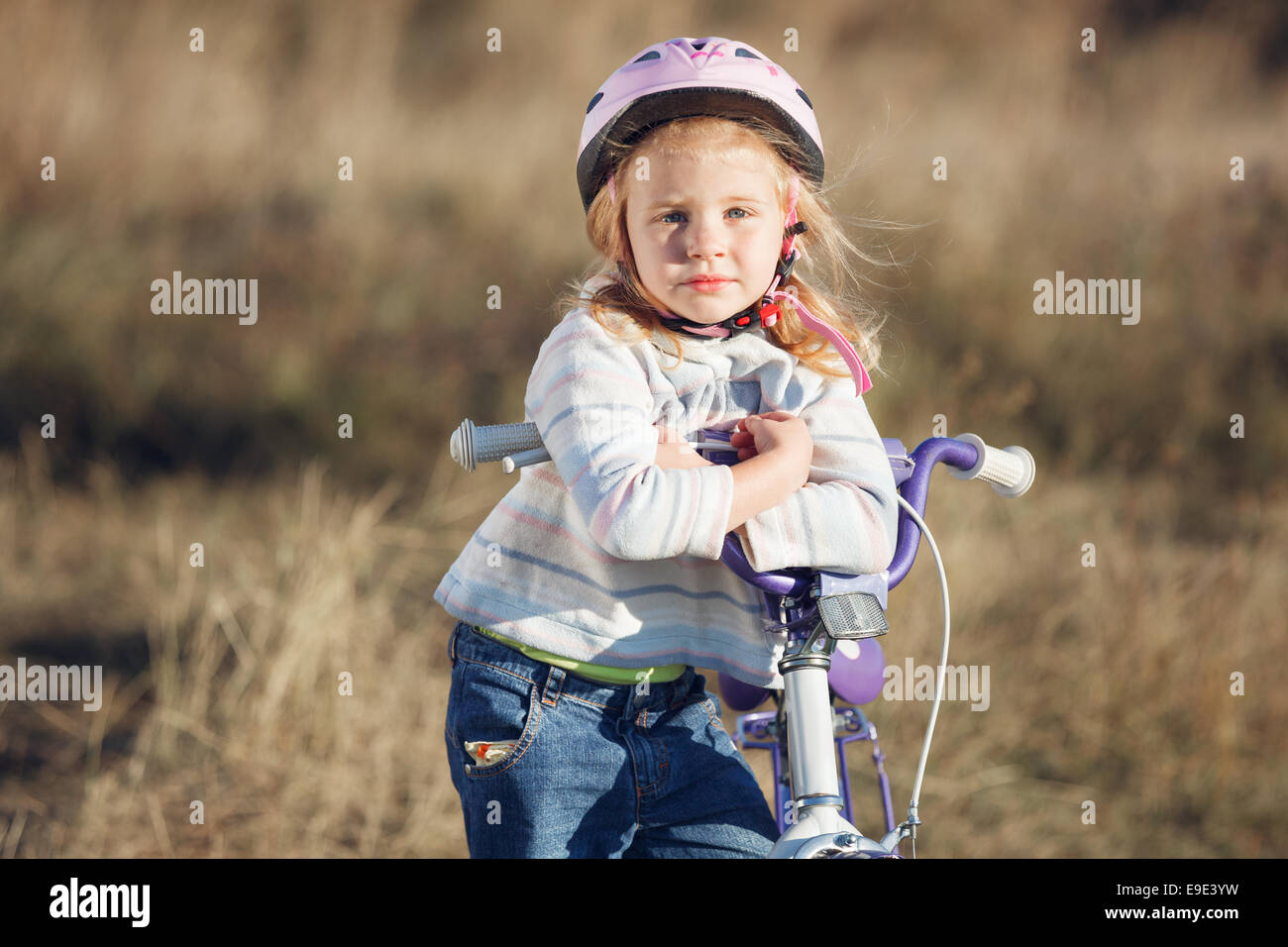Small funny kid riding bike with training wheels Stock Photo Alamy
