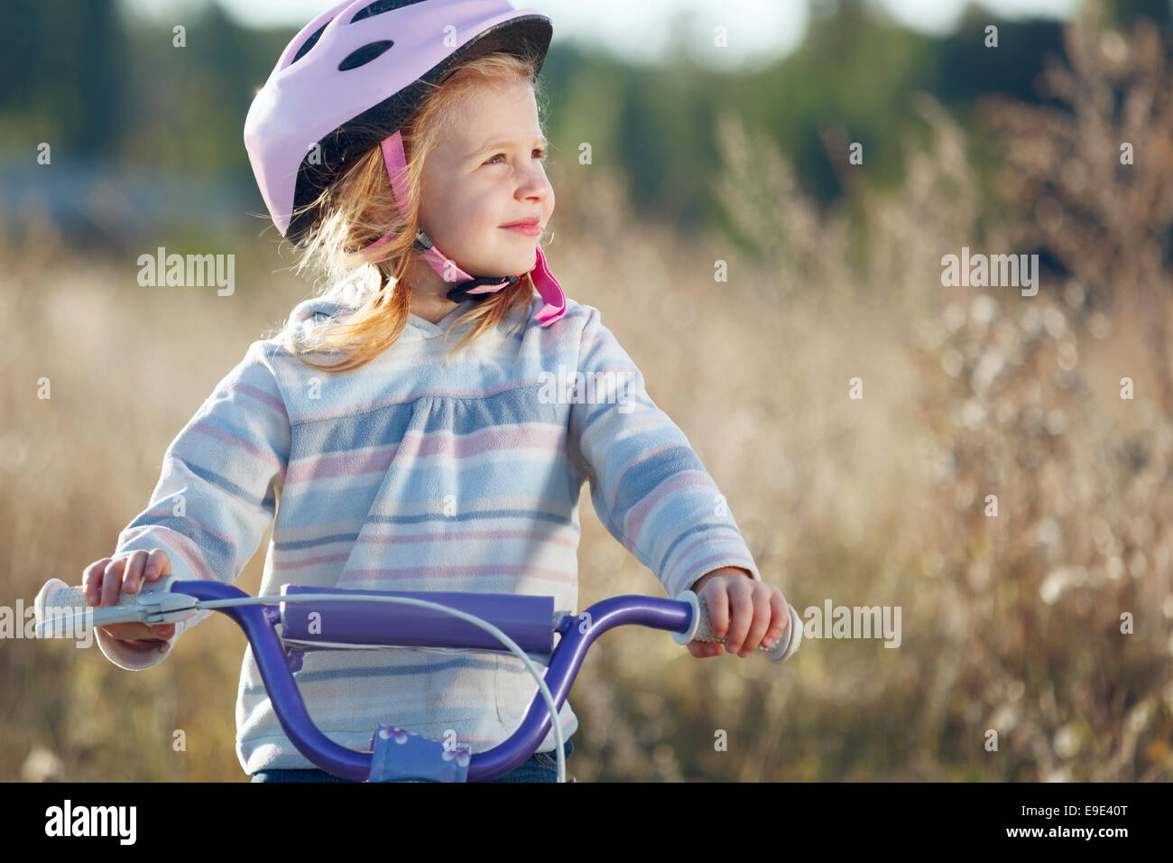 Small funny kid riding bike with training wheels Stock Photo Alamy