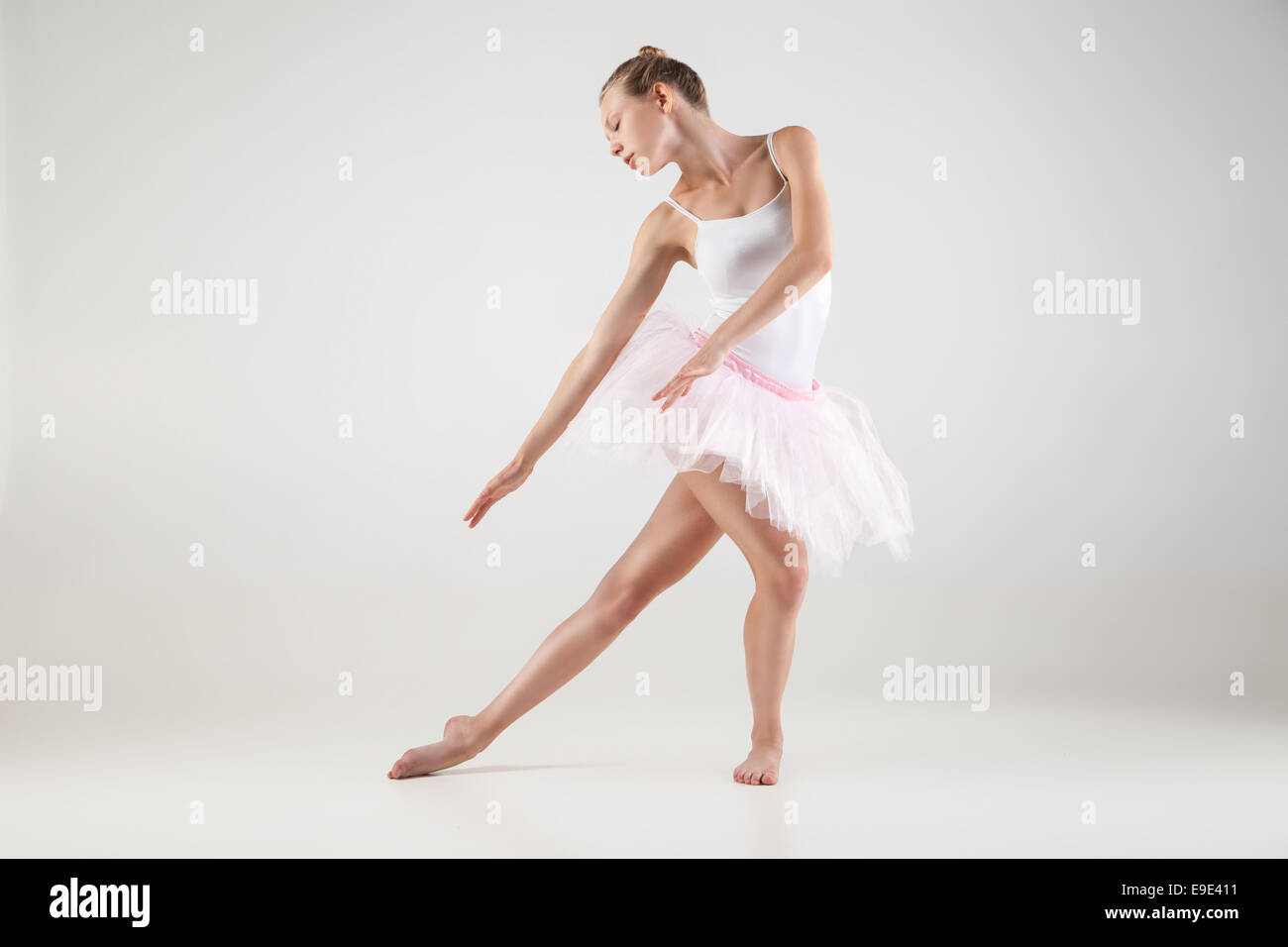 Ballerina in classical tutu over the white studio background Stock