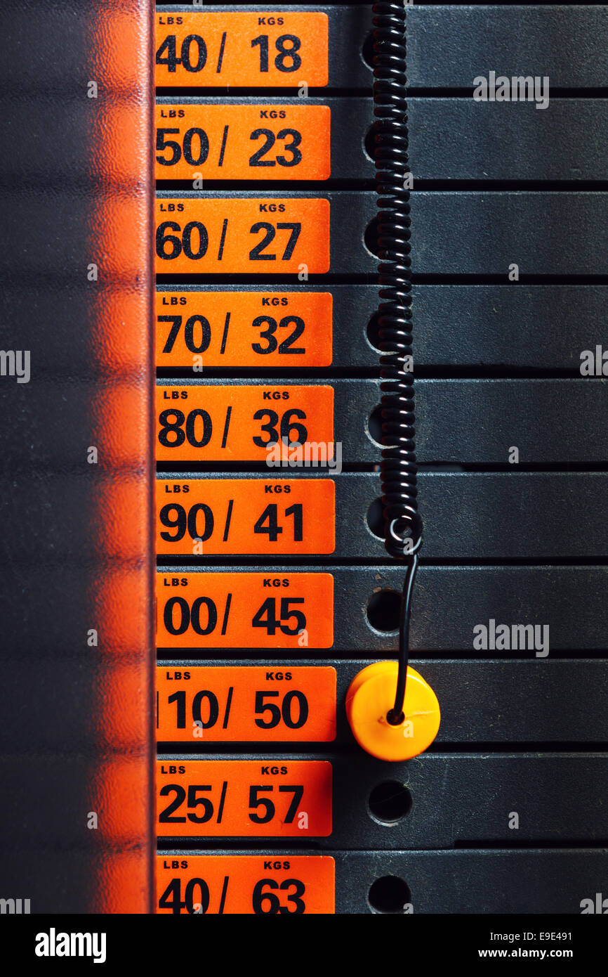 Closeup of weight stack with orange pin Stock Photo - Alamy