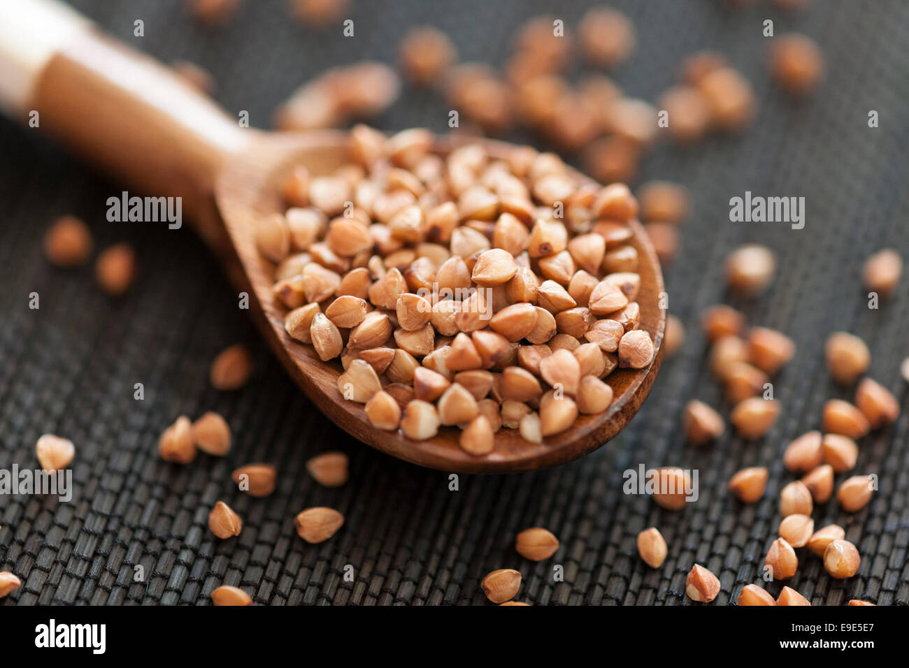Buckwheat in wooden spoon. Stock Photo