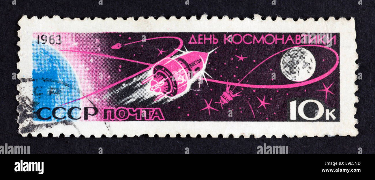 USSR postage stamp Cosmonauts Day - Vostok 1- Earth and the Moon. 1963 year. Black background. Stock Photo