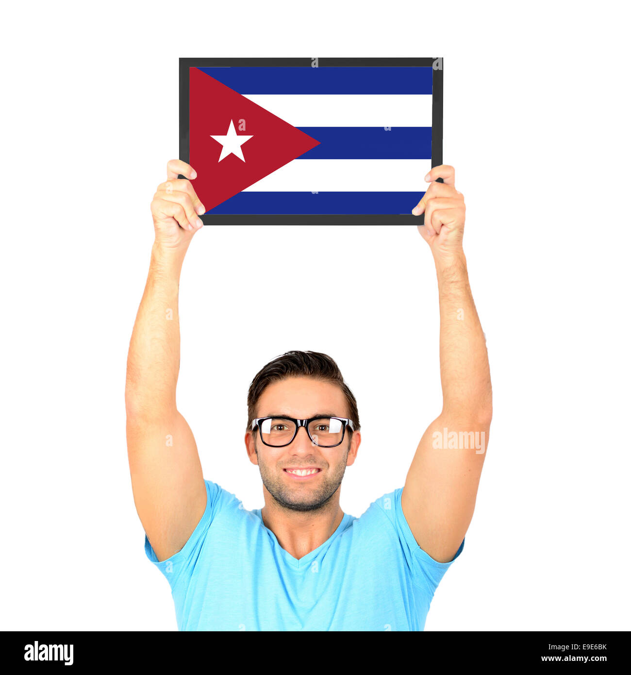 Portrait of a young casual man holding up board with National flag of Cuba Stock Photo