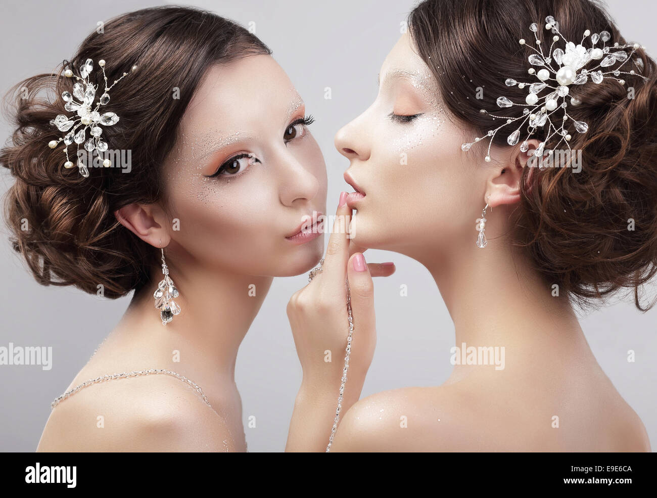 Sensuality. Two Women Fashion Models with Trendy Make-up Stock Photo