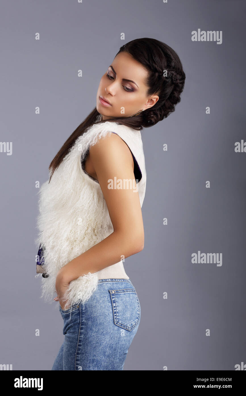 Trendy Woman in Sleeveless Jacket and Jeans Stock Photo