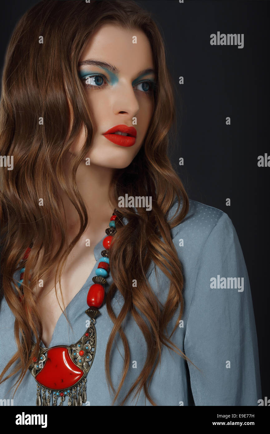 Young Woman with Bright Makeup and Necklace Stock Photo