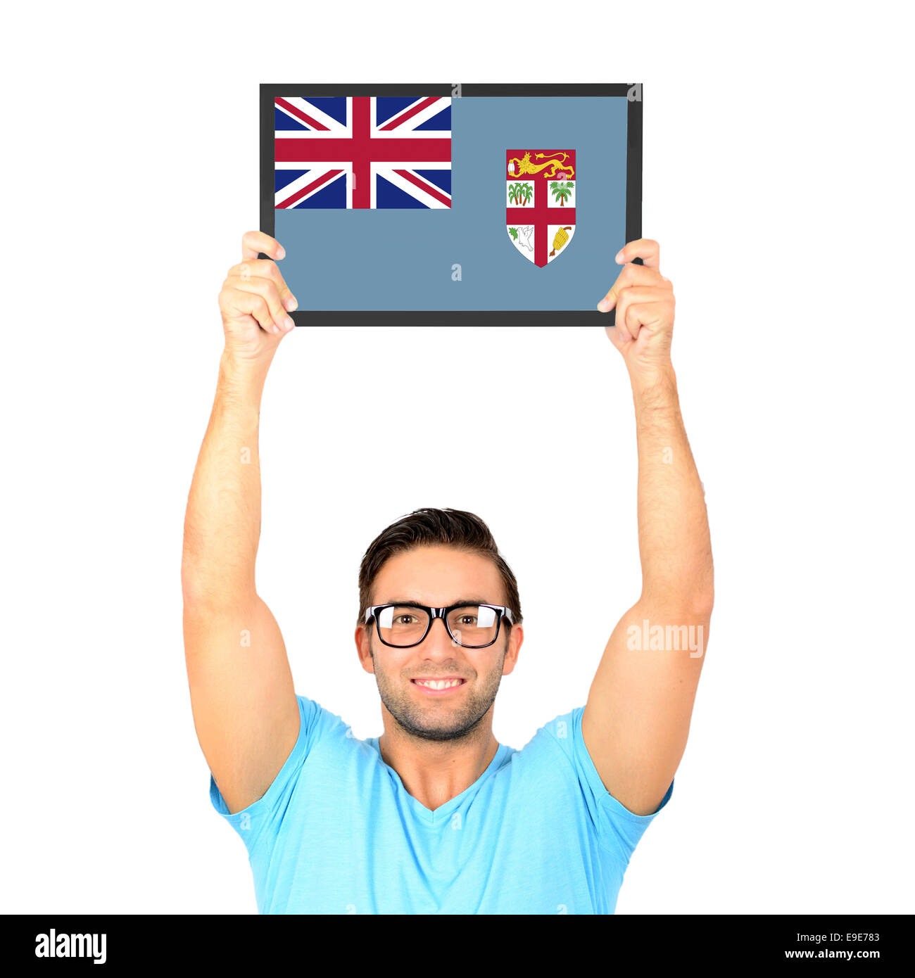 Portrait of a young casual man holding up board with National flag of Fiji Stock Photo
