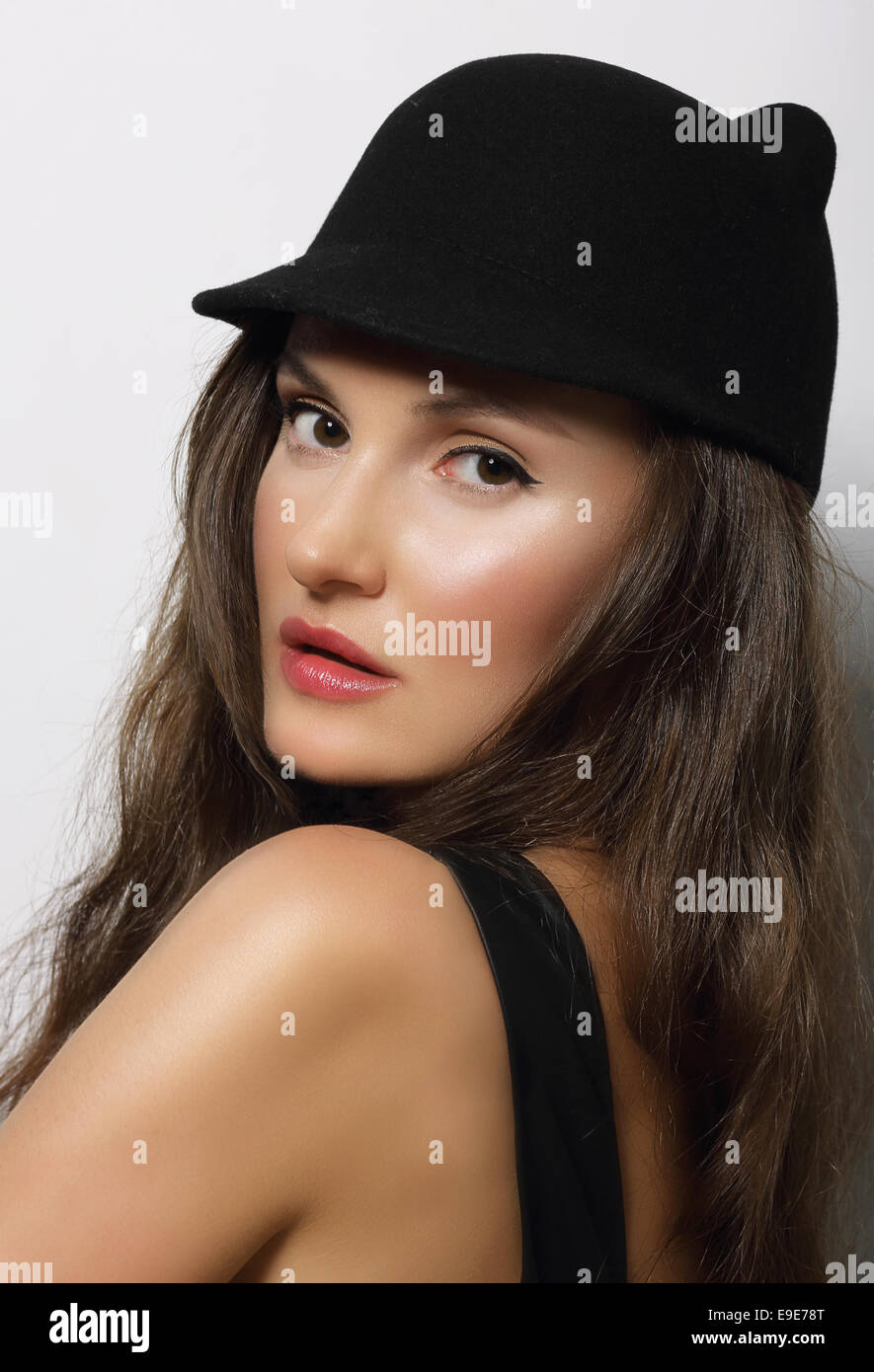Portrait of Young Woman in Dark Hat Stock Photo