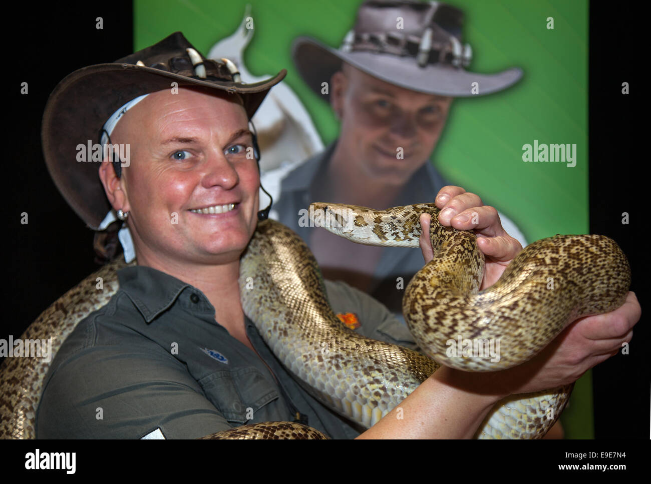 Crocodile Joe McQuade, 39, holding large Burmese python snake at the Family Pet Show, EventCity, Trafford Centre, Manchester’s biggest and most flexible event venue. Stock Photo