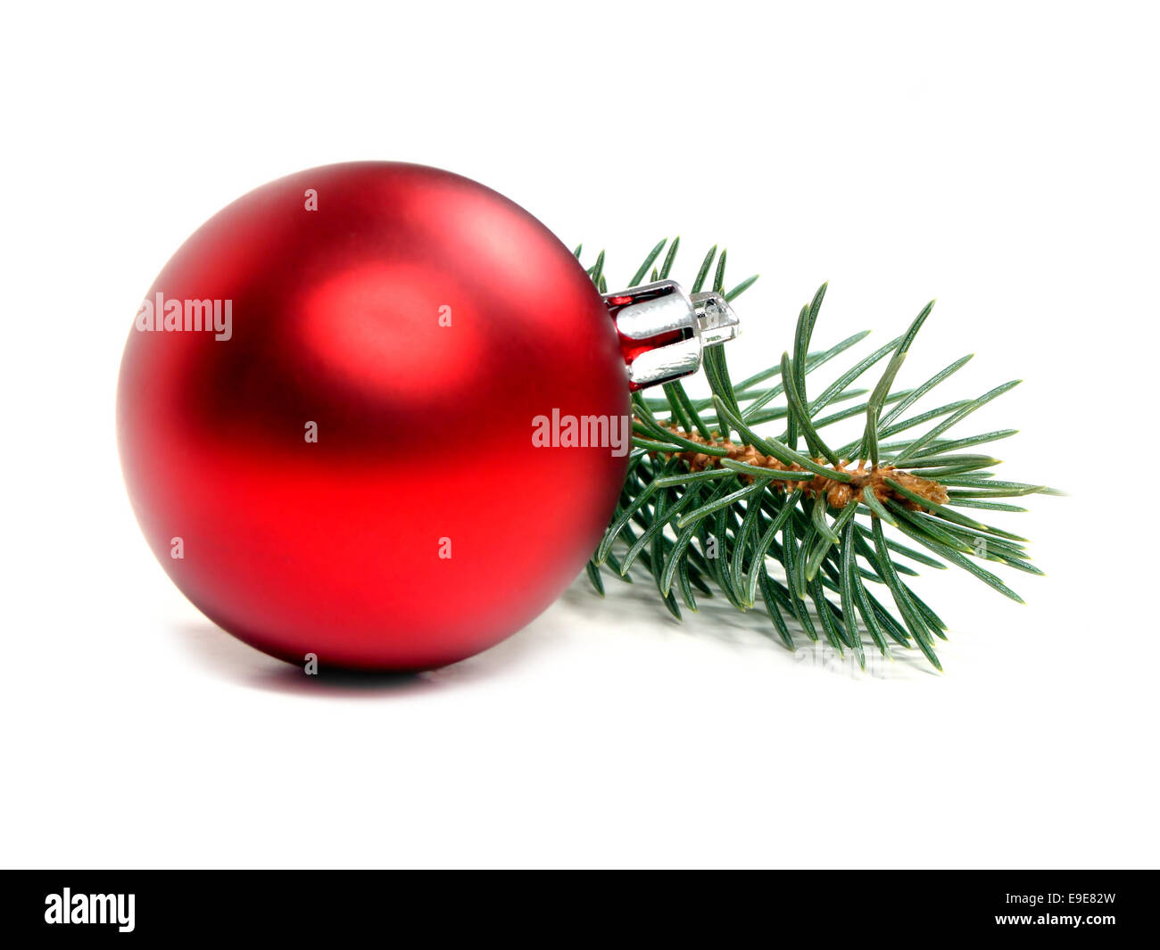 Single red Christmas bauble and tree branch on a white background Stock ...