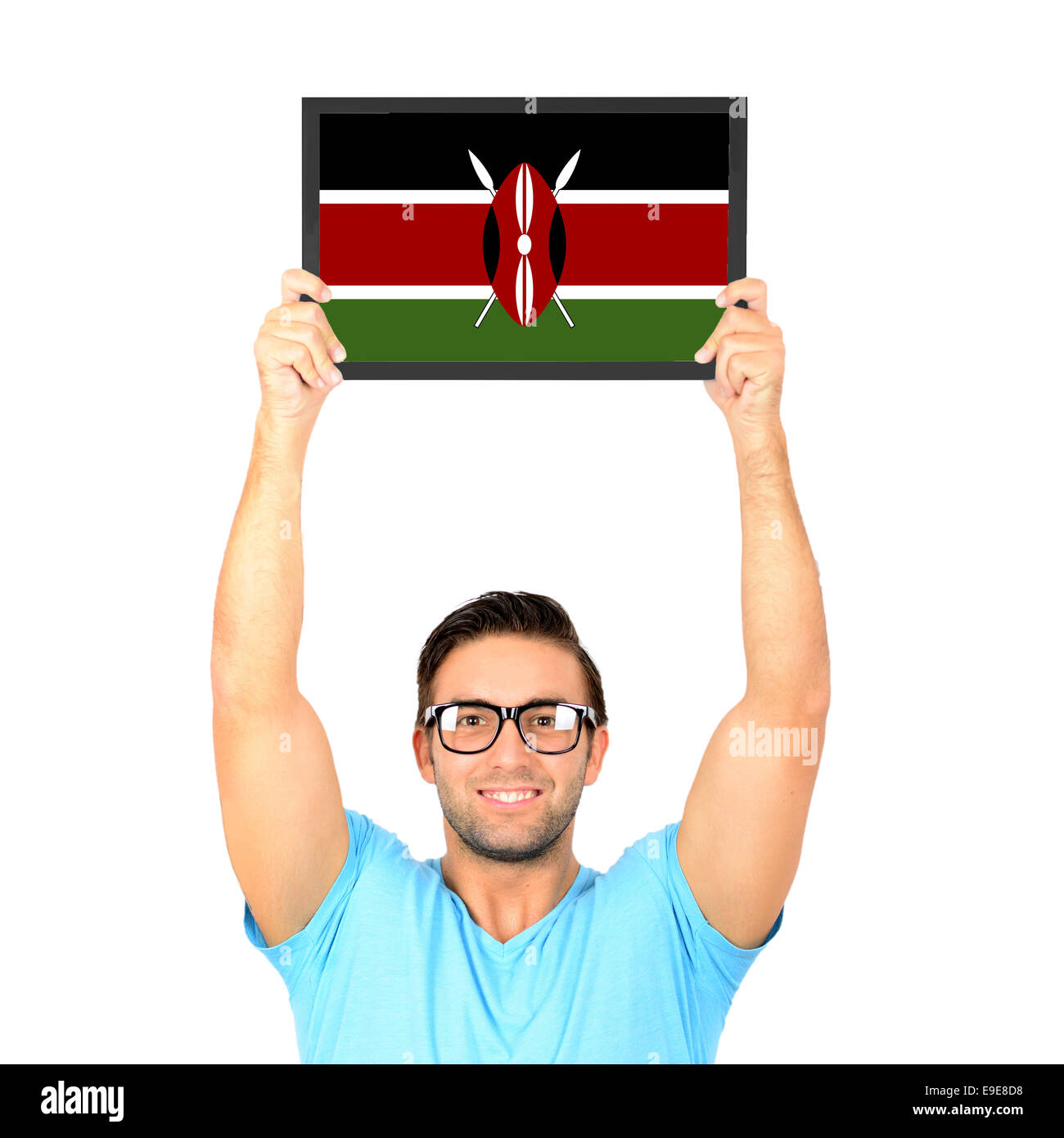 Portrait of a young casual man holding up board with National flag of Kenya Stock Photo