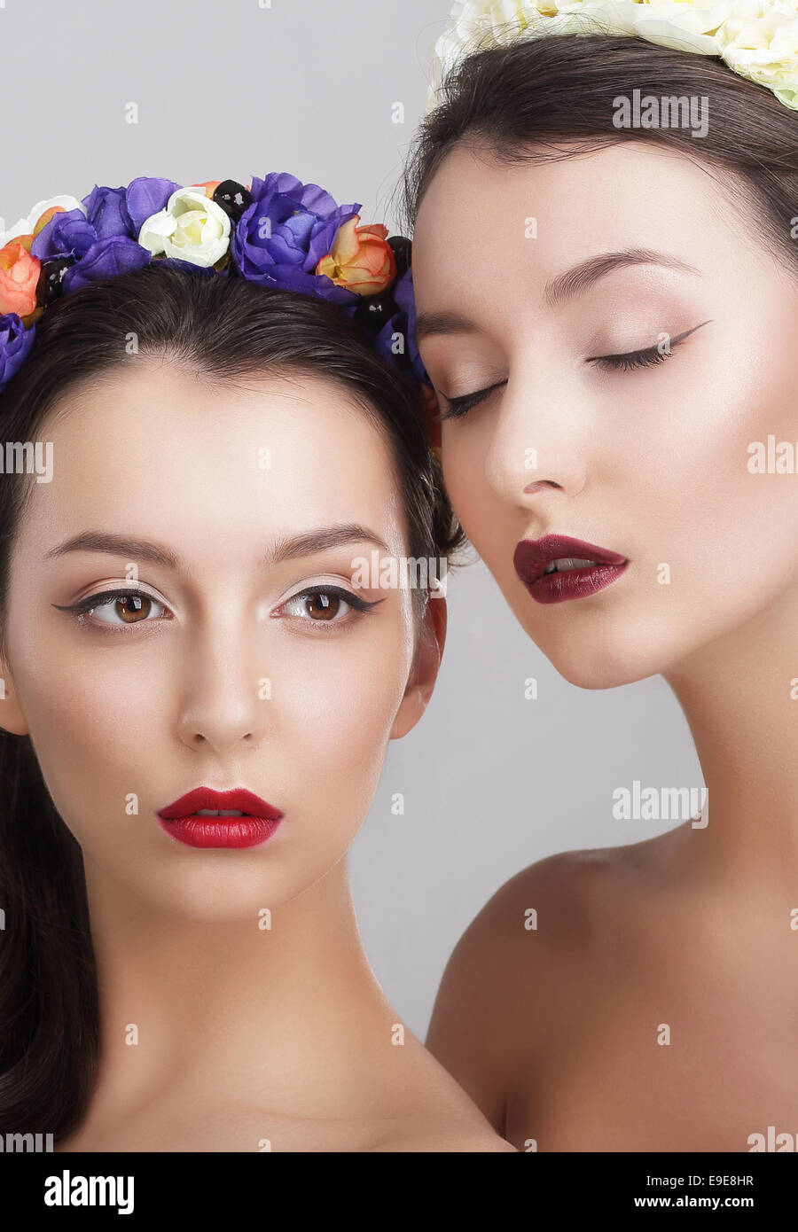 Imagination. Women in Garlands with Vernal Flowers Stock Photo