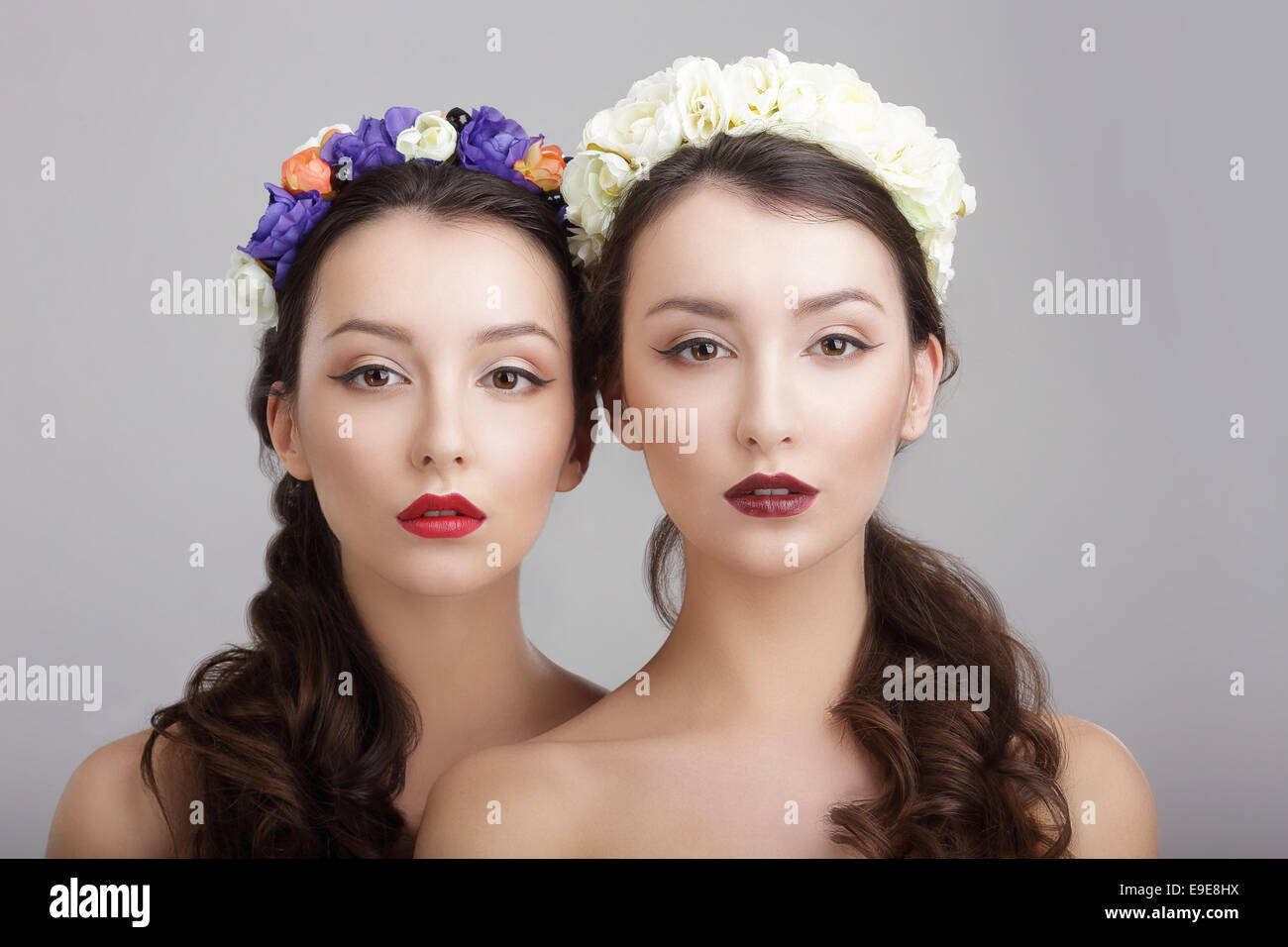 Elegance. Two Women with Wreaths of Flowers. Fantasy Stock Photo