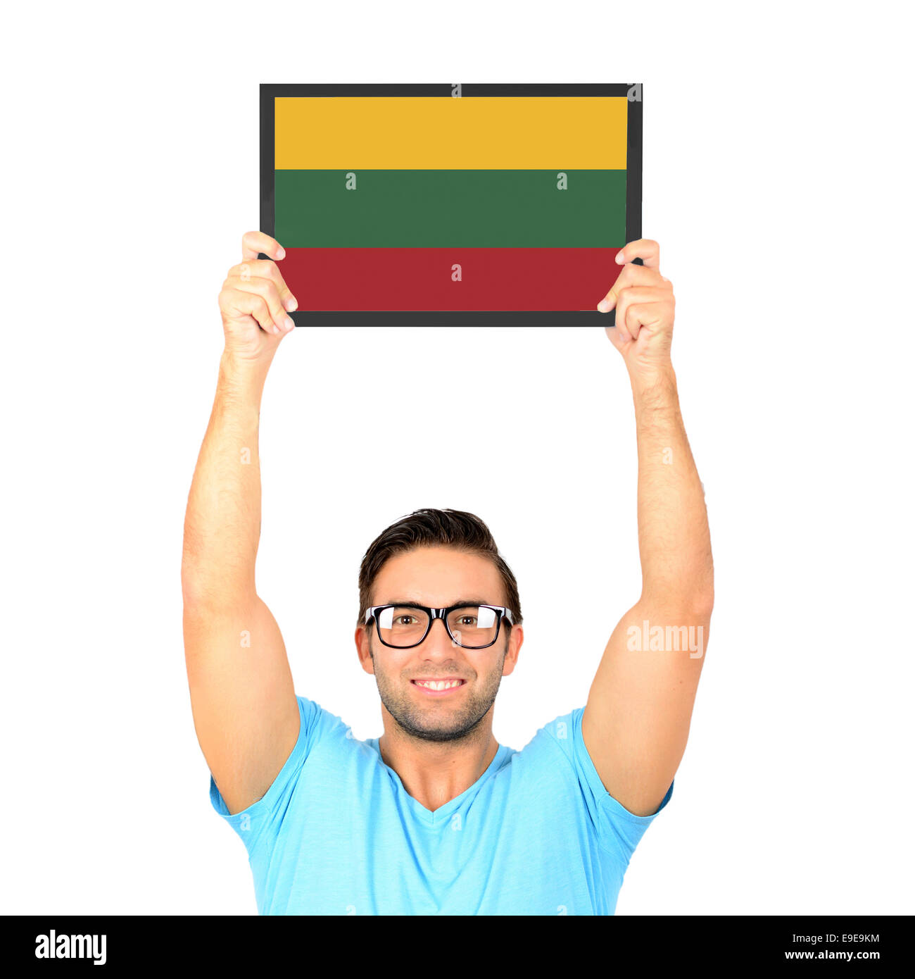Portrait of a young casual man holding up board with National flag of Lithuania Stock Photo