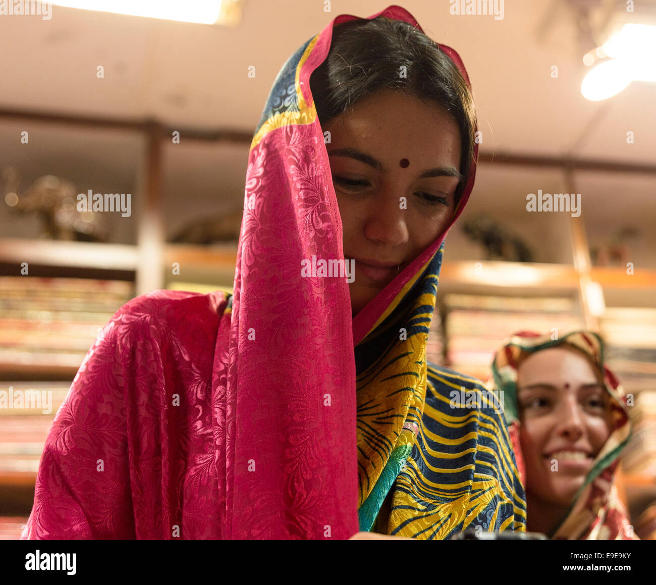 Two western women trying saris in a shop. Delhi, India Stock Photo