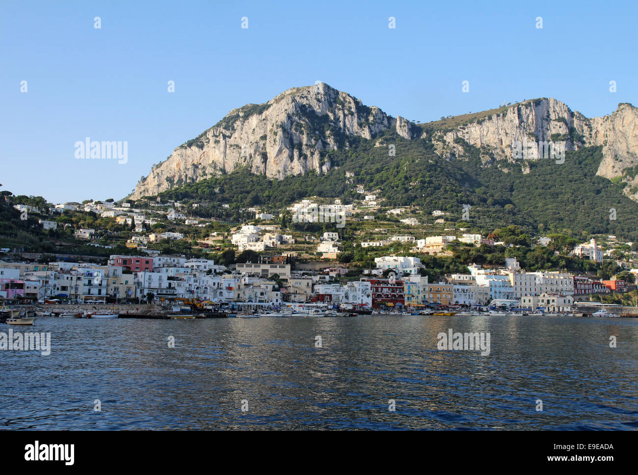 Boats and buildings of Marina Grande on the island of Capri, Italy, with mountains in the background Stock Photo