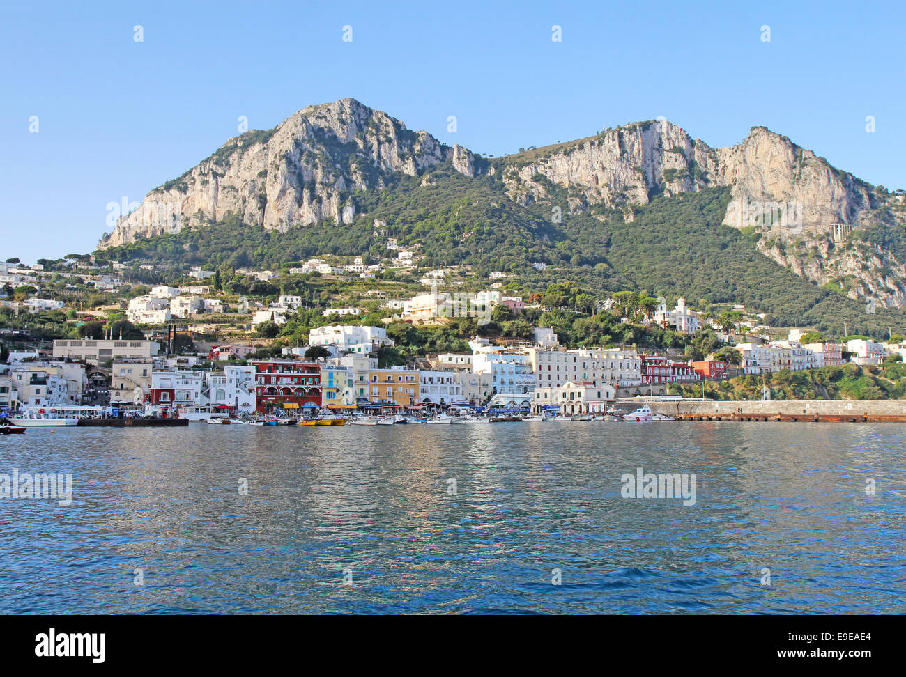 Boats and buildings of Marina Grande on the island of Capri, Italy, with mountains in the background Stock Photo