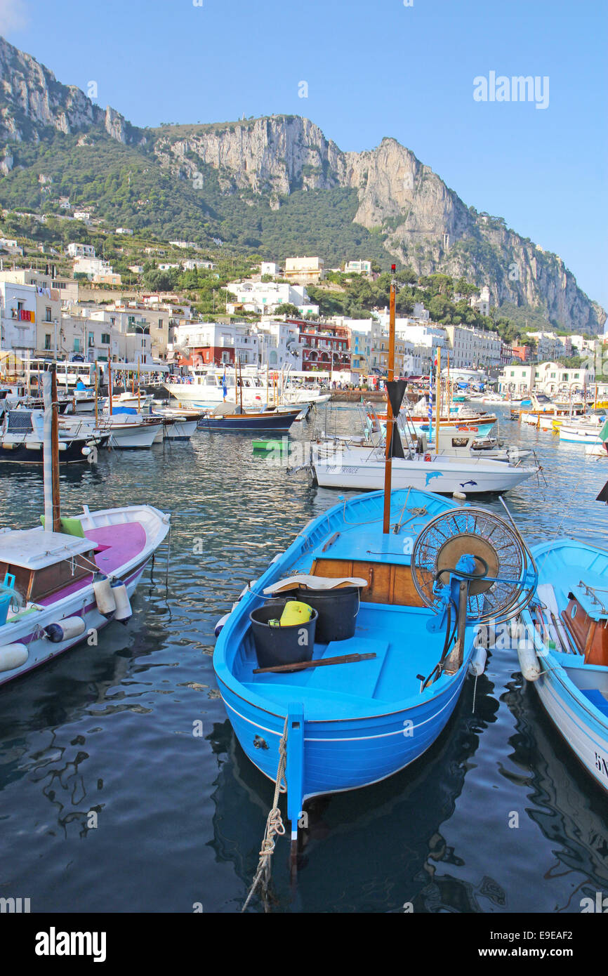 Boats and buildings of Marina Grande on the island of Capri, Italy, with mountains in the background vertical Stock Photo