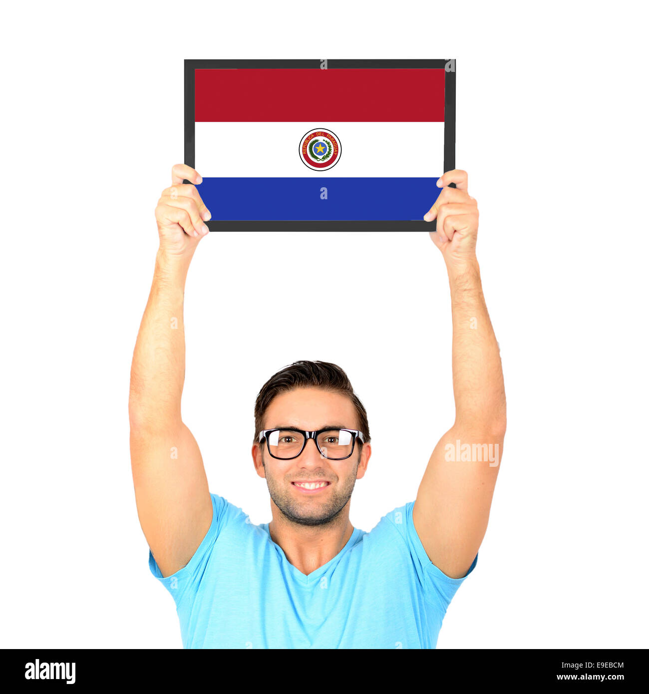 Portrait of a young casual man holding up board with National flag of Paraguay Stock Photo