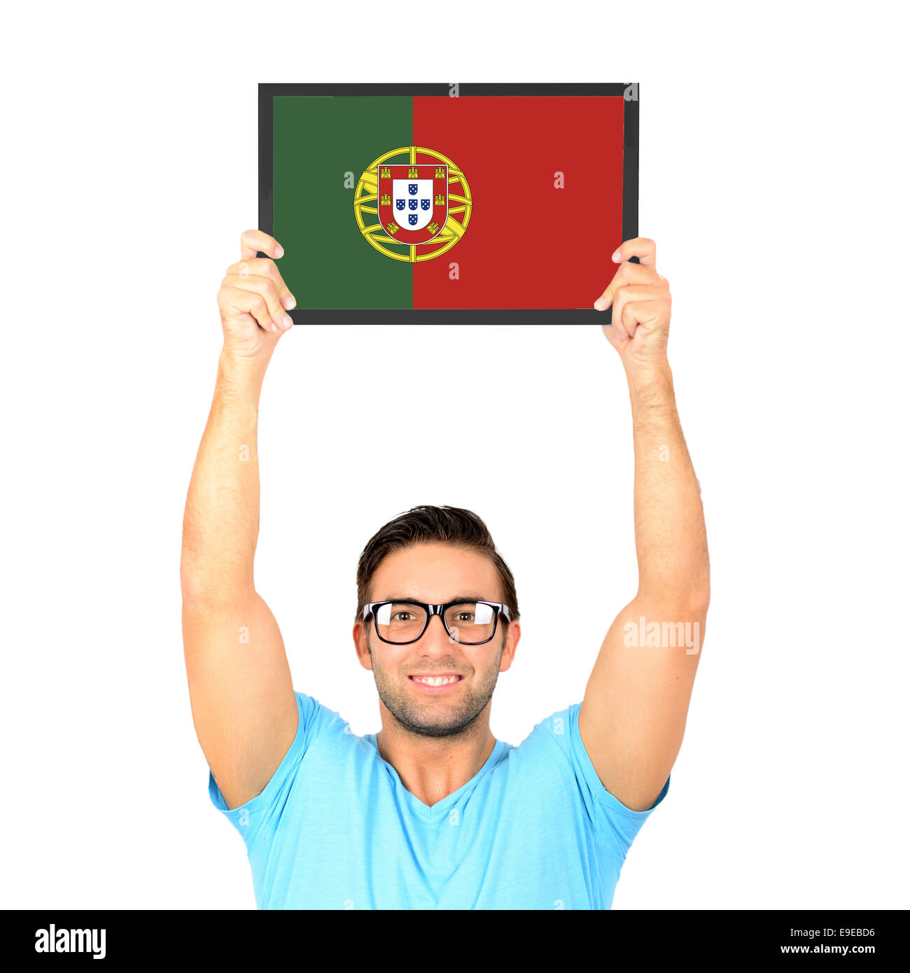 Portrait of a young casual man holding up board with National flag of Portugal Stock Photo