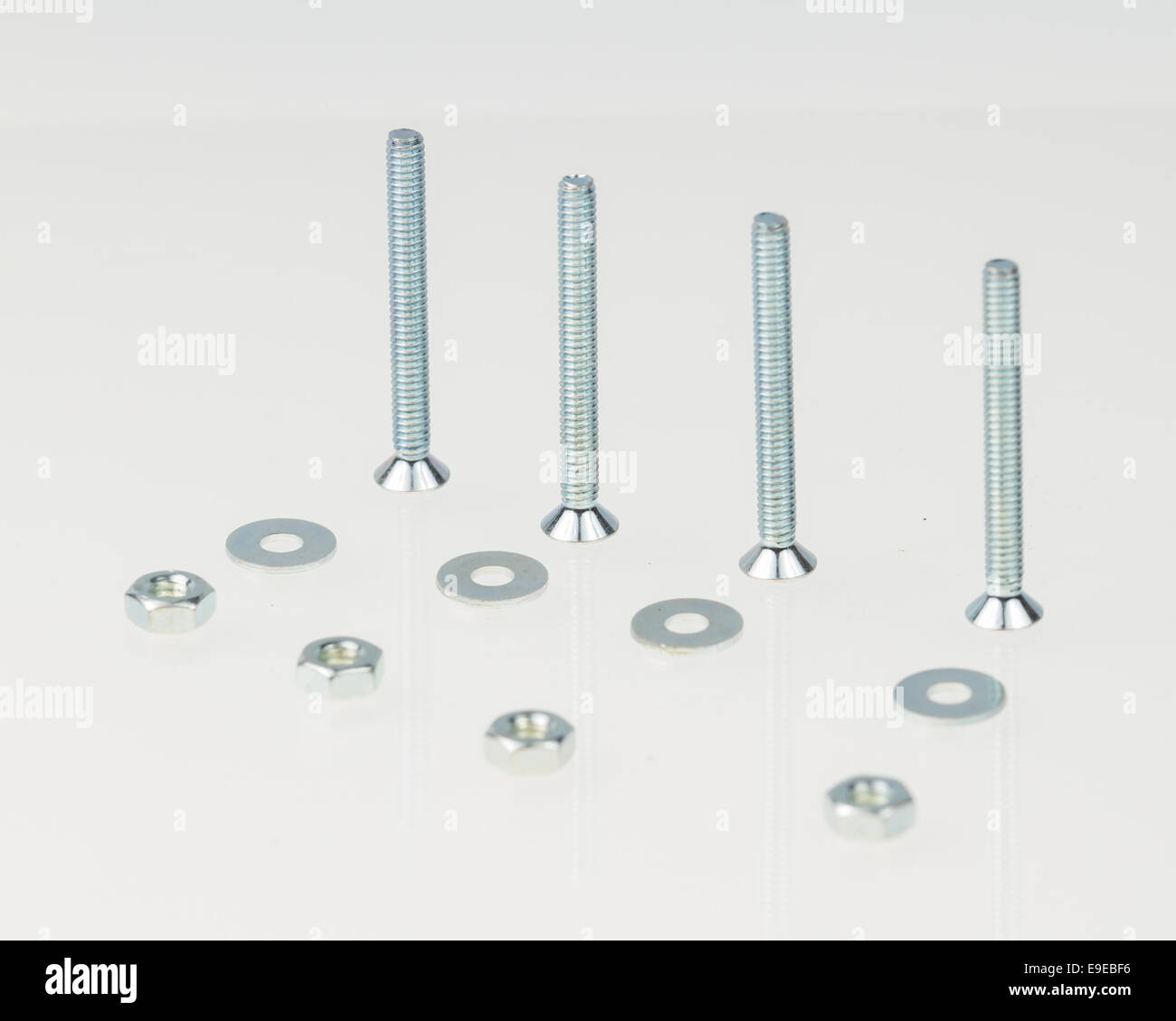 Screws, nuts, and bolts on isolated white background Stock Photo Alamy